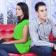 Unhappy Indian couple on a couch