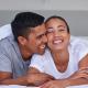 Laughing couple in bed