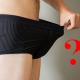 Man looking inside his boxer shorts