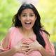Shocked indian woman with hands on chest